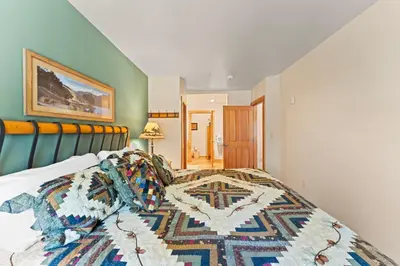 a bedroom with a bed with a rug on it at Expedition Station 8603 in Keystone