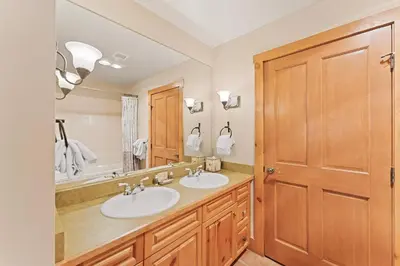 a bathroom with two sinks and a large mirror at Expedition Station 8603 in Keystone