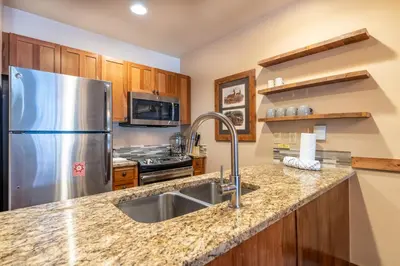 a kitchen with a stainless steel refrigerator and a sink at Red Hawk Lodge 2271 : 300 in Keystone