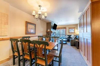 a dining room and living room with a table and chairs at Red Hawk Lodge 2271 : 300 in Keystone