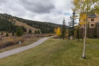 a path in a field next to a house at Red Hawk Lodge 2271 : 300 in Keystone