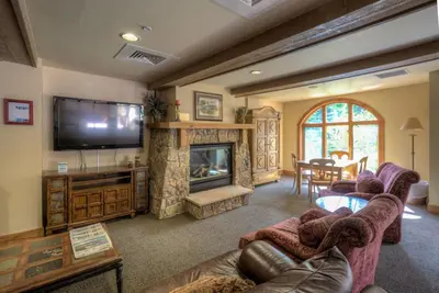 a living room with couches and a television and a fireplace at Red Hawk Lodge 2271 : 300 in Keystone