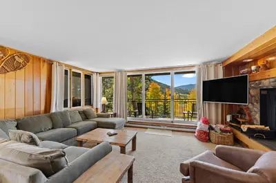 a living room with a couch and a tv at Pines 2166 in Keystone