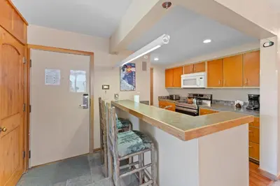 a kitchen with wooden cabinets and a counter top at Pines 2166 in Keystone