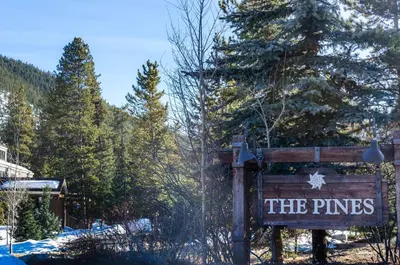 a sign for the pines at a ski resort at Pines 2166 in Keystone