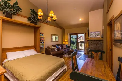a bedroom with a bed and a living room at Red Hawk Lodge 2313 in Keystone