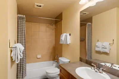 a bathroom with a sink and a toilet and a shower at Red Hawk Lodge 2313 in Keystone