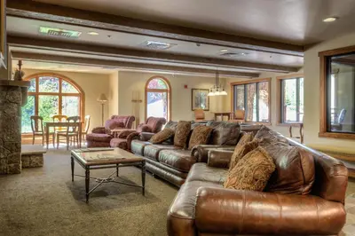 a living room with a leather couch and a table at Red Hawk Lodge 2313 in Keystone
