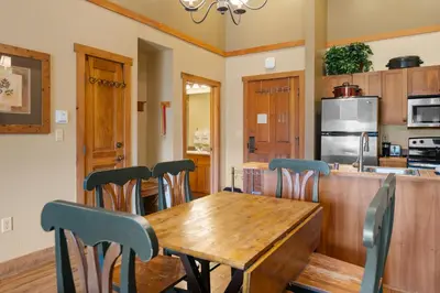 a kitchen and dining room with a wooden table and chairs at Red Hawk Lodge 2313 in Keystone