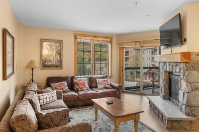 a living room with a couch and a fireplace at Dakota Lodge 8517 in Keystone