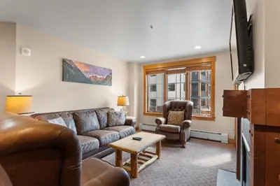 a living room with a couch and a chair at Springs 8845 in Keystone