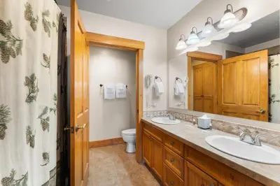 a bathroom with two sinks and a toilet at Springs 8845 in Keystone