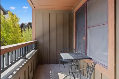 a balcony with a table and a laptop on it at Springs 8845 in Keystone