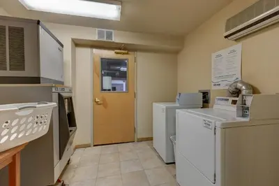 a laundry room with white appliances and a door at Gateway 5053 in Keystone