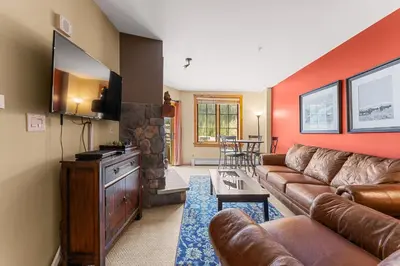 a living room with a couch and a tv at Dakota Lodge 8512 in Keystone