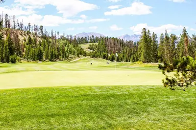 a view of a golf course with a green at Dakota Lodge 8512 in Keystone