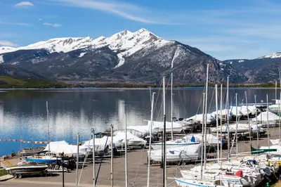 a bunch of boats docked at a marina with a mountain at Dakota Lodge 8512 in Keystone