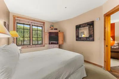 a bedroom with a white bed and a window at Dakota Lodge 8512 in Keystone