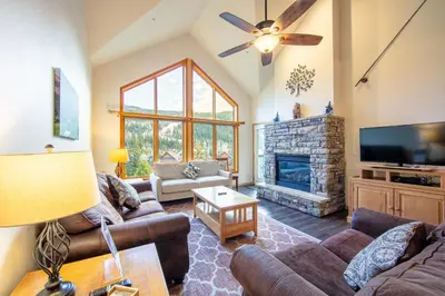 a living room with couches and a tv and a fireplace at Gateway 5097 in Keystone