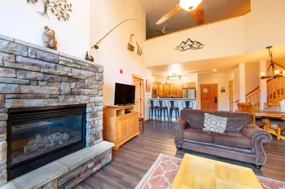 a living room with a couch and a fireplace at Gateway 5097 in Keystone