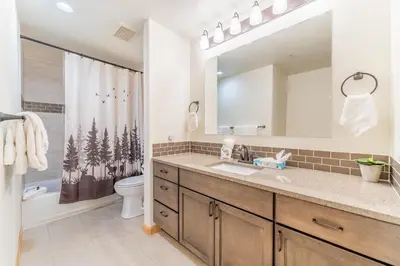 a bathroom with a sink and a shower curtain at Gateway 5097 in Keystone