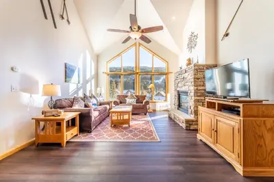a living room with a couch and a tv at Gateway 5097 in Keystone