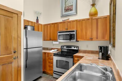 a kitchen with stainless steel appliances and wooden cabinets at Red Hawk Lodge 2312 in Keystone