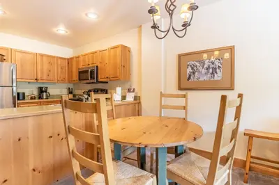 a kitchen with a wooden table and chairs at Expedition Station 8581 in Keystone