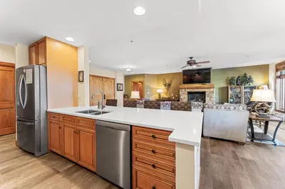 a kitchen with a sink and a refrigerator at Timbers 3073: 2250 in Keystone