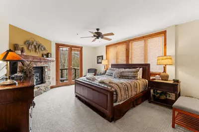 a bedroom with a bed and a fireplace at Timbers 3073: 2250 in Keystone