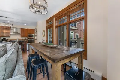 a kitchen and living room with a wooden table at Lone Eagle 3021 in Keystone