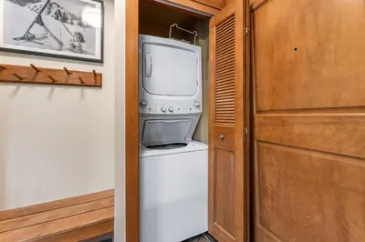 a kitchen with a washer and dryer next to a door at Lone Eagle 3021 in Keystone