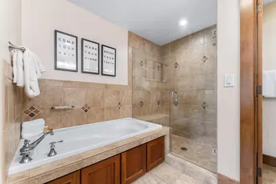 a bathroom with a bath tub and a shower at Lone Eagle 3021 in Keystone