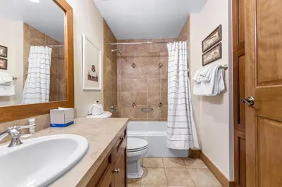 a bathroom with a sink and a toilet and a shower at Lone Eagle 3021 in Keystone