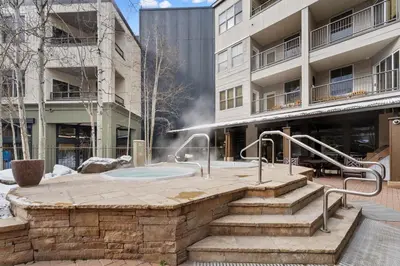 a hot tub in a courtyard in front of a building at Silver Mill 8266 in Keystone