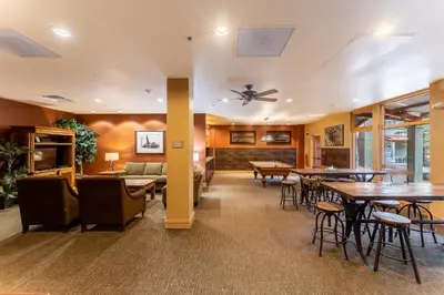 a restaurant with tables and chairs and a couch at Silver Mill 8266 in Keystone