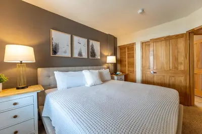 a bedroom with a bed with a white comforter at Silver Mill 8266 in Keystone