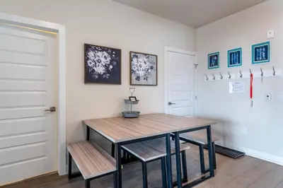 a dining room with a table and two benches at Sail Lofts 303 in Dillon