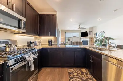 a kitchen with wooden cabinets and a stove top oven at Sail Lofts 303 in Dillon