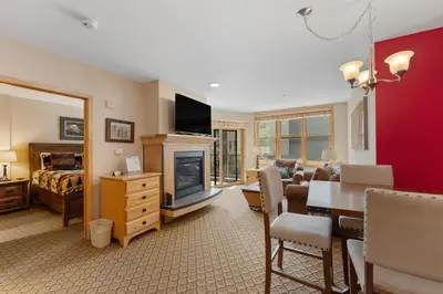 a living room with a couch and a table and a fireplace at Silver Mill 8171 in Keystone