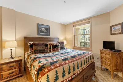 a bedroom with a bed and a tv and a window at Silver Mill 8171 in Keystone