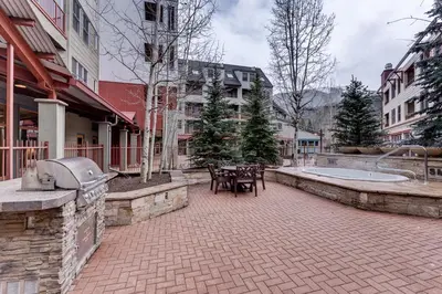 a courtyard with tables and chairs in a city at Silver Mill 8171 in Keystone