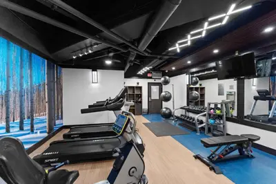 a gym with treadmills and exercise equipment in a room at Silver Mill 8171 in Keystone