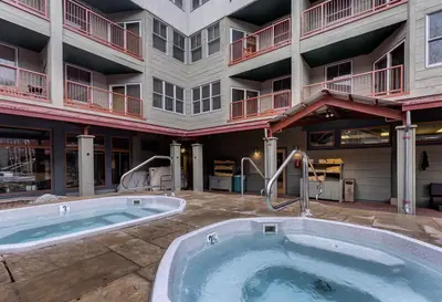 a building with a hot tub in front of a building at Silver Mill 8171 in Keystone