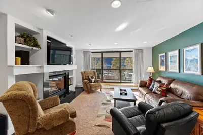 a living room with a couch and a fireplace at Saints John 2500 in Keystone