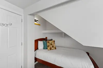 a bedroom with a bed with white walls at Saints John 2500 in Keystone