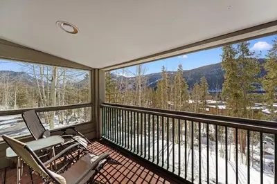 a balcony with two chairs and a view of the mountains at Saints John 2500 in Keystone
