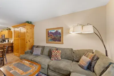 a living room with a couch and a table at Expedition Station 8576 in Keystone