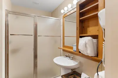 a bathroom with a shower and a toilet and a sink at Expedition Station 8576 in Keystone