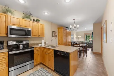 a kitchen with wooden cabinets and a stove top oven at Expedition Station 8576 in Keystone